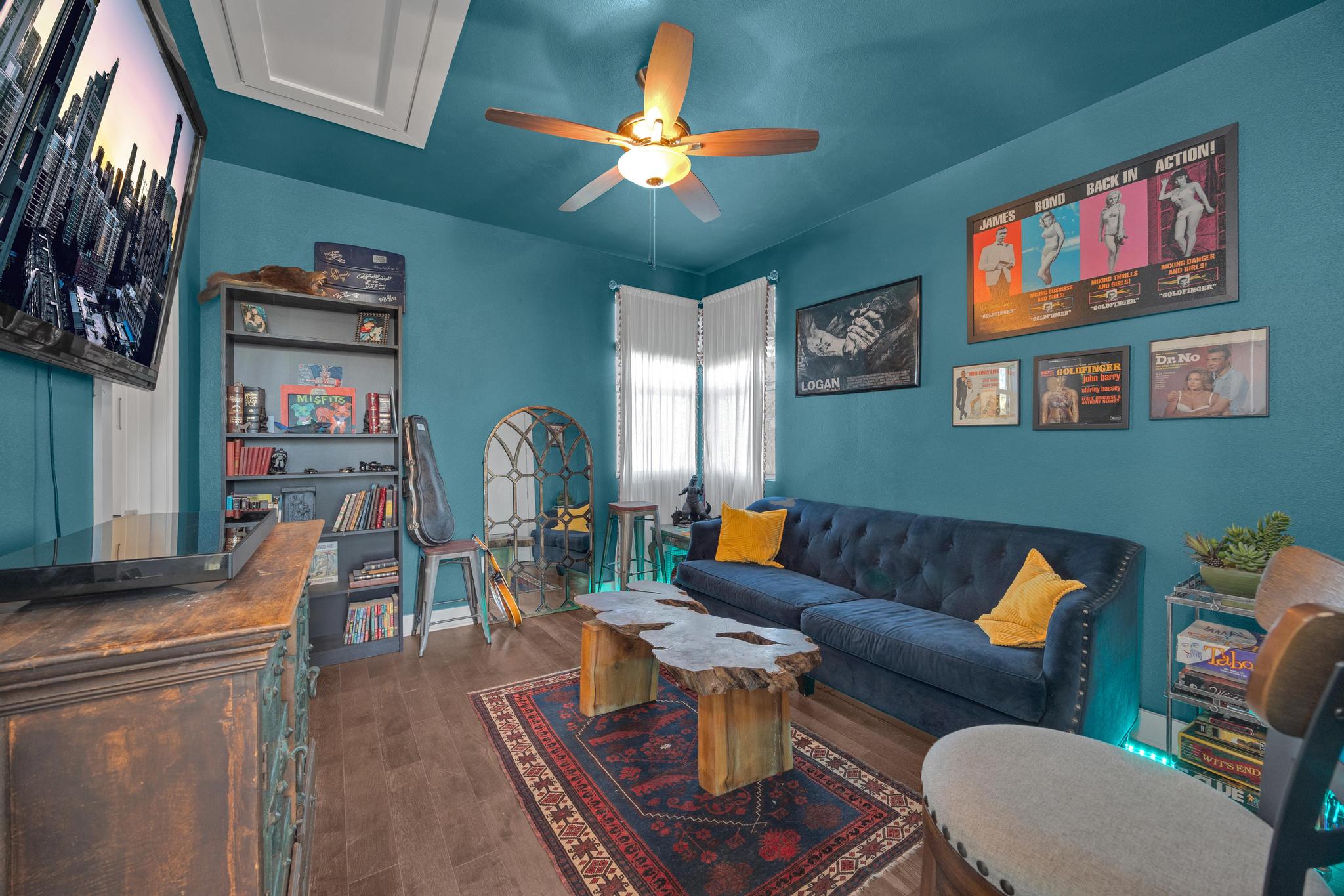 4404 Clarkson Avenue Austin, TX 78751 - Photo 21 of 35 a living room with furniture a desk and chair with wooden floor
