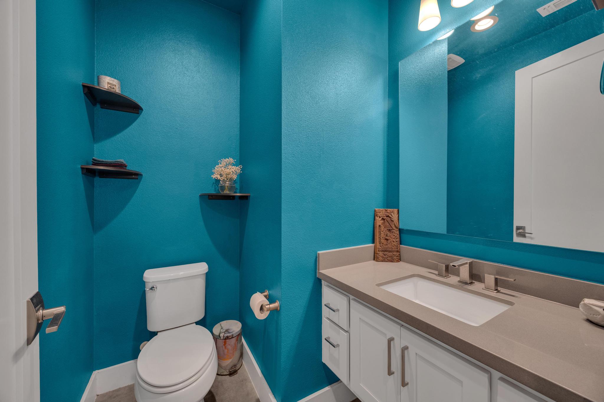 4404 Clarkson Avenue Austin, TX 78751 - Photo 22 of 35 a bathroom with a granite countertop toilet sink and mirror