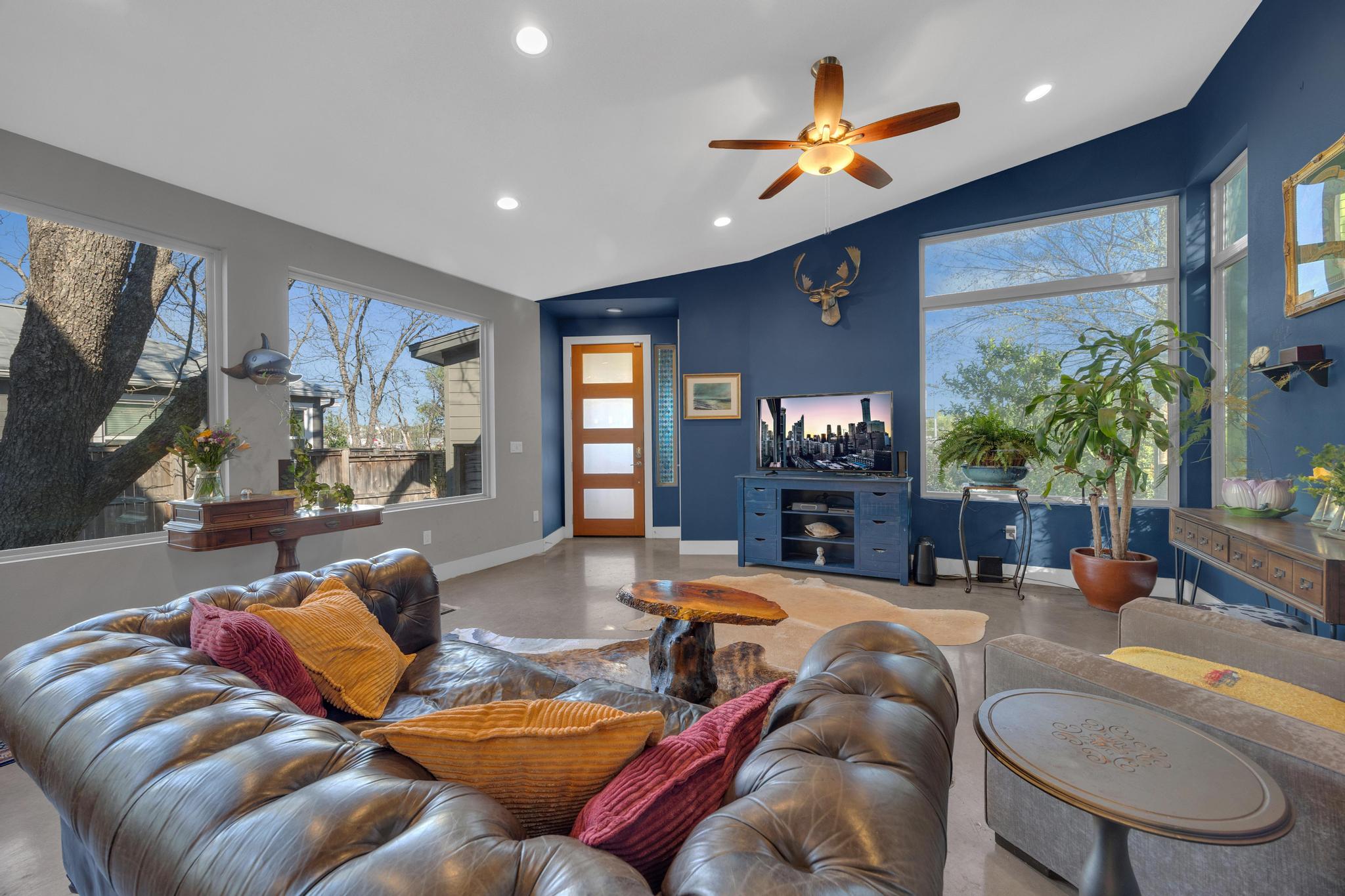 4404 Clarkson Avenue Austin, TX 78751 - Photo 6 of 35 a living room with furniture ceiling fan and a rug