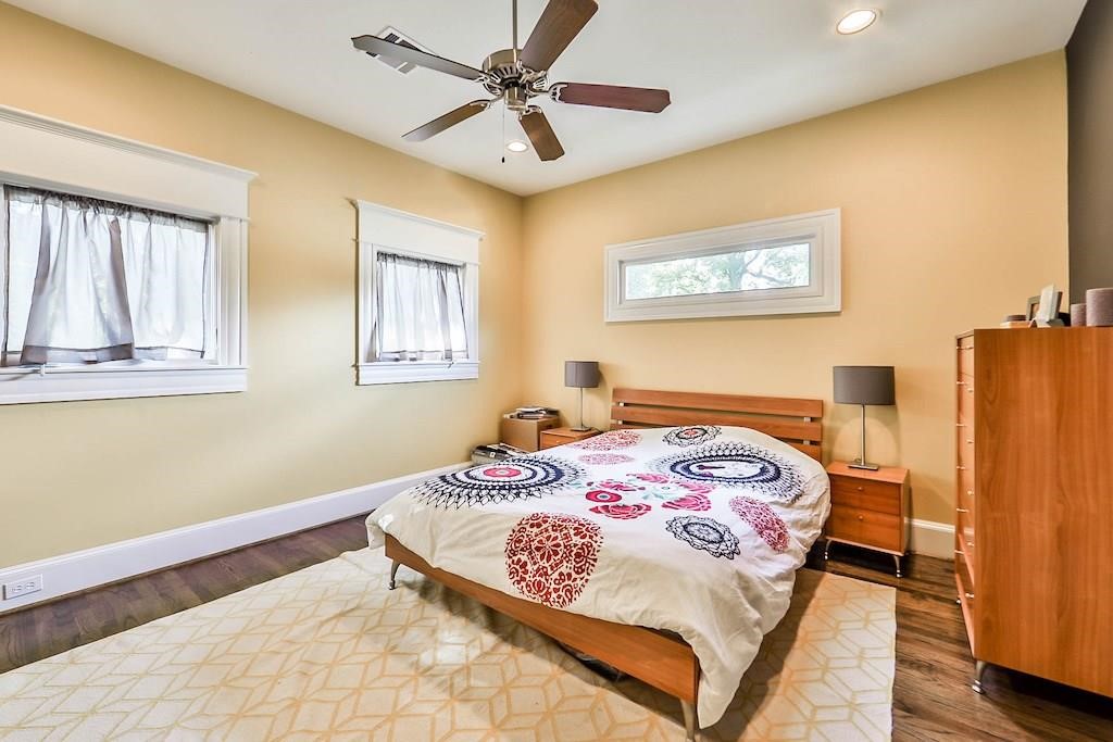 1436 Harvard Street Houston, TX 77008 - Photo 18 of 18 a bedroom with a bed and wooden floor