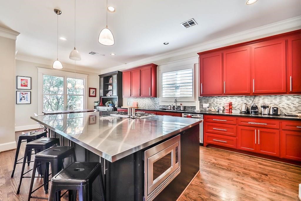 1436 Harvard Street Houston, TX 77008 - Photo 9 of 18 a kitchen with stainless steel appliances granite countertop a sink a stove a table and chairs