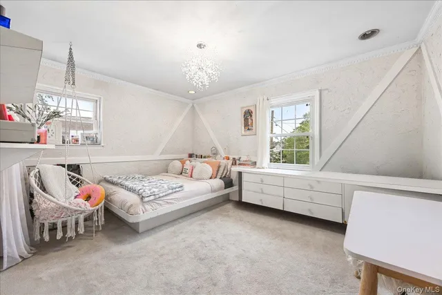 a bedroom with furniture and a window