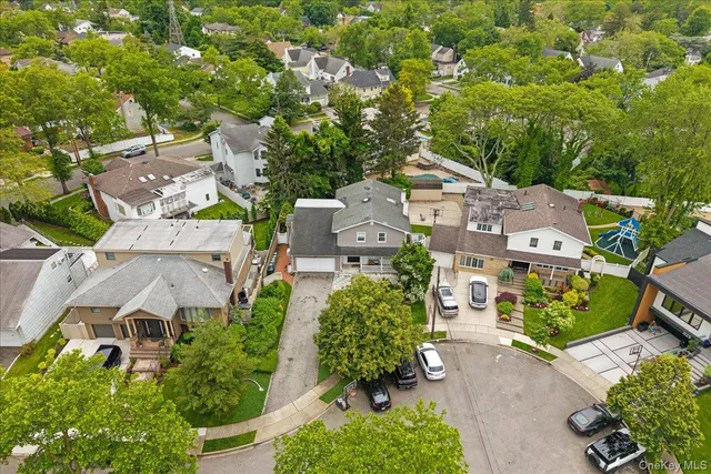 an aerial view of a house with a yard basket ball court and outdoor seating