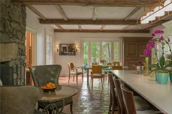 a dining room with furniture a chandelier and wooden floor