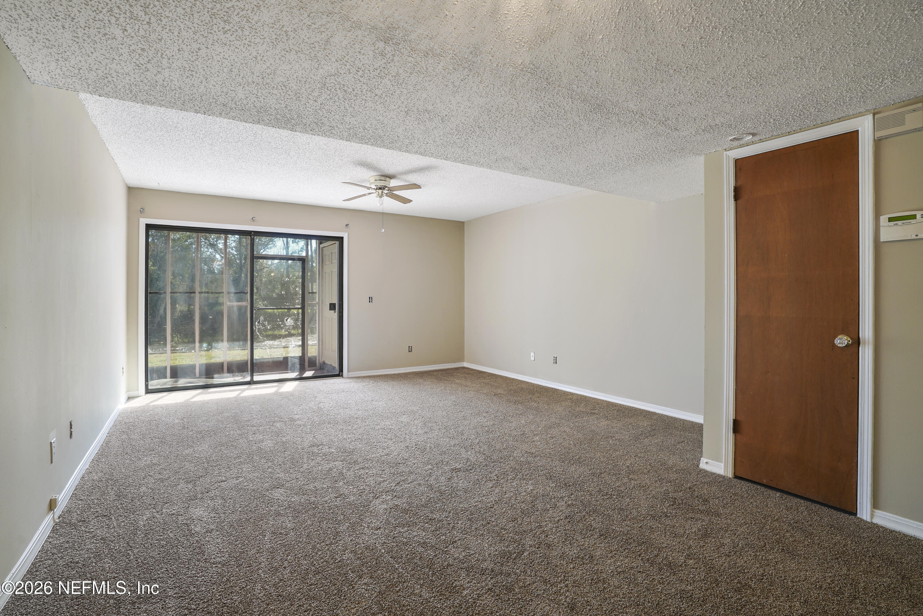 3517 Peeler Road, Unit 23 Jacksonville, FL 32277 - Photo 12 of 24 a view of an empty room with a window