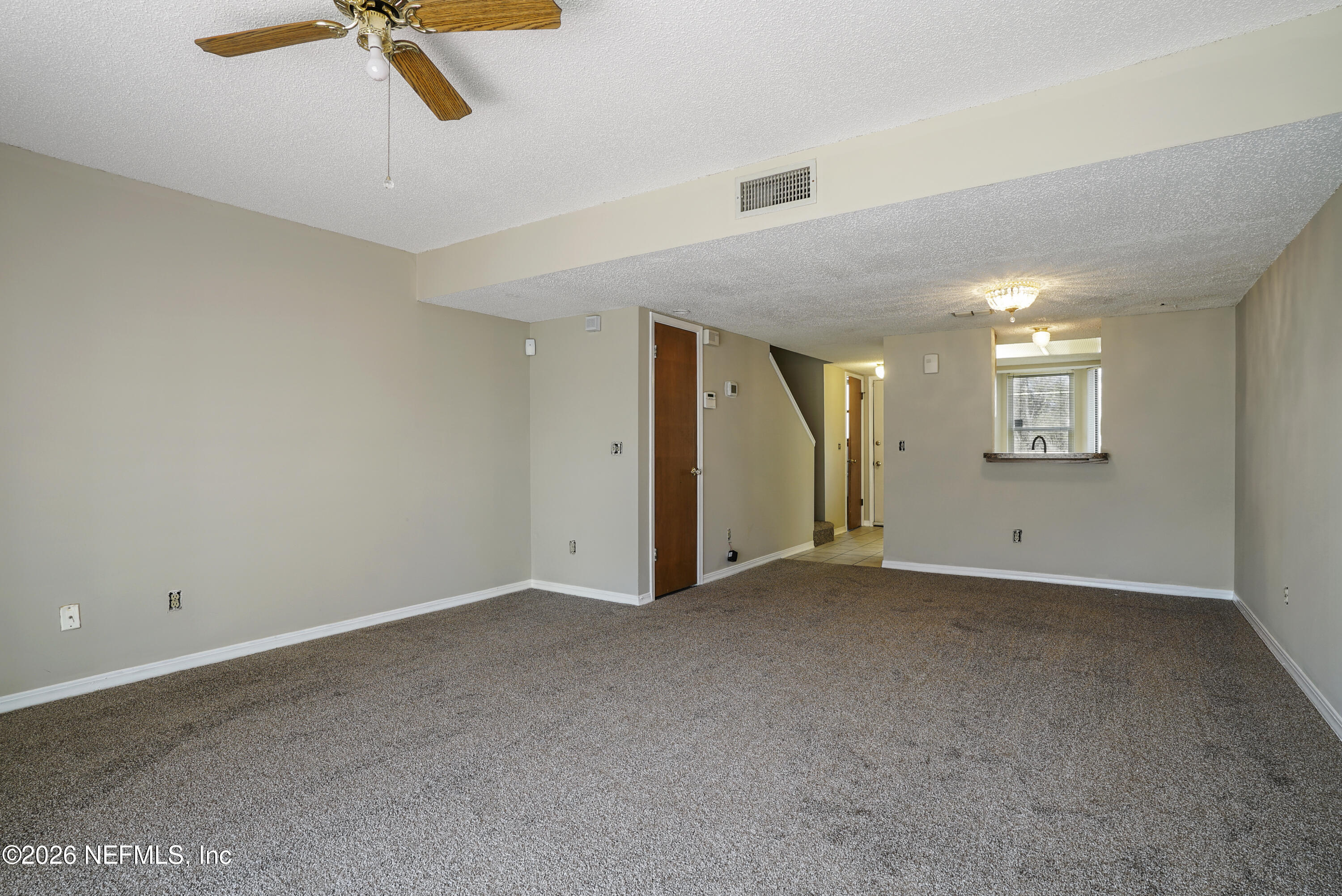 3517 Peeler Road, Unit 23 Jacksonville, FL 32277 - Photo 13 of 24 a view of an empty room with chandelier fan