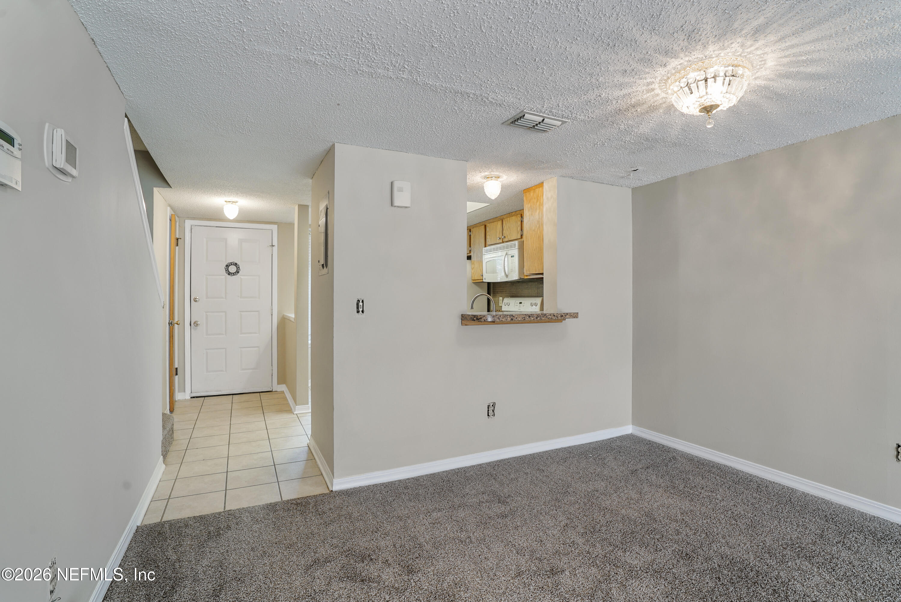 3517 Peeler Road, Unit 23 Jacksonville, FL 32277 - Photo 15 of 24 wooden floor in an empty room with a window