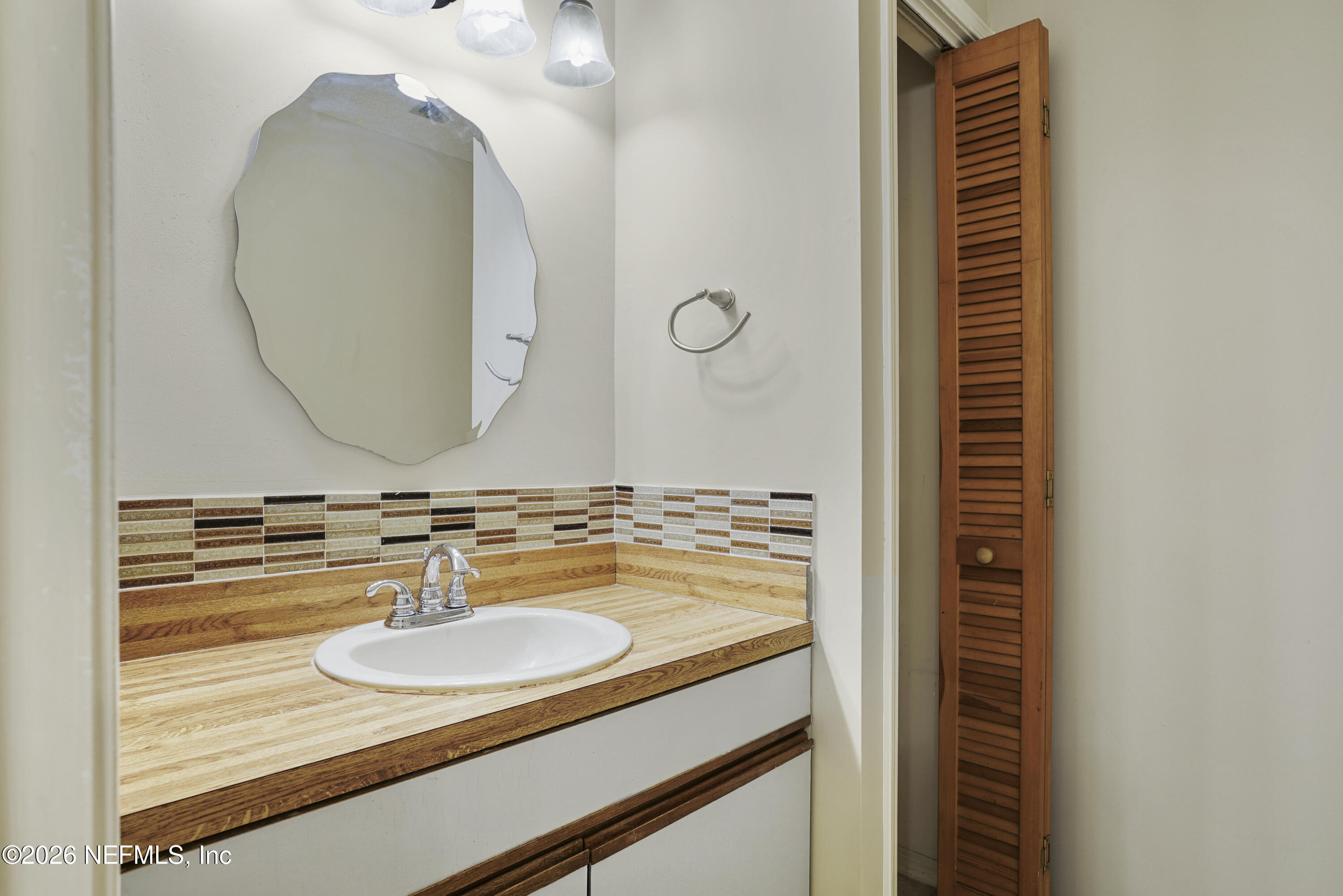 3517 Peeler Road, Unit 23 Jacksonville, FL 32277 - Photo 19 of 24 a bathroom with a sink and a mirror