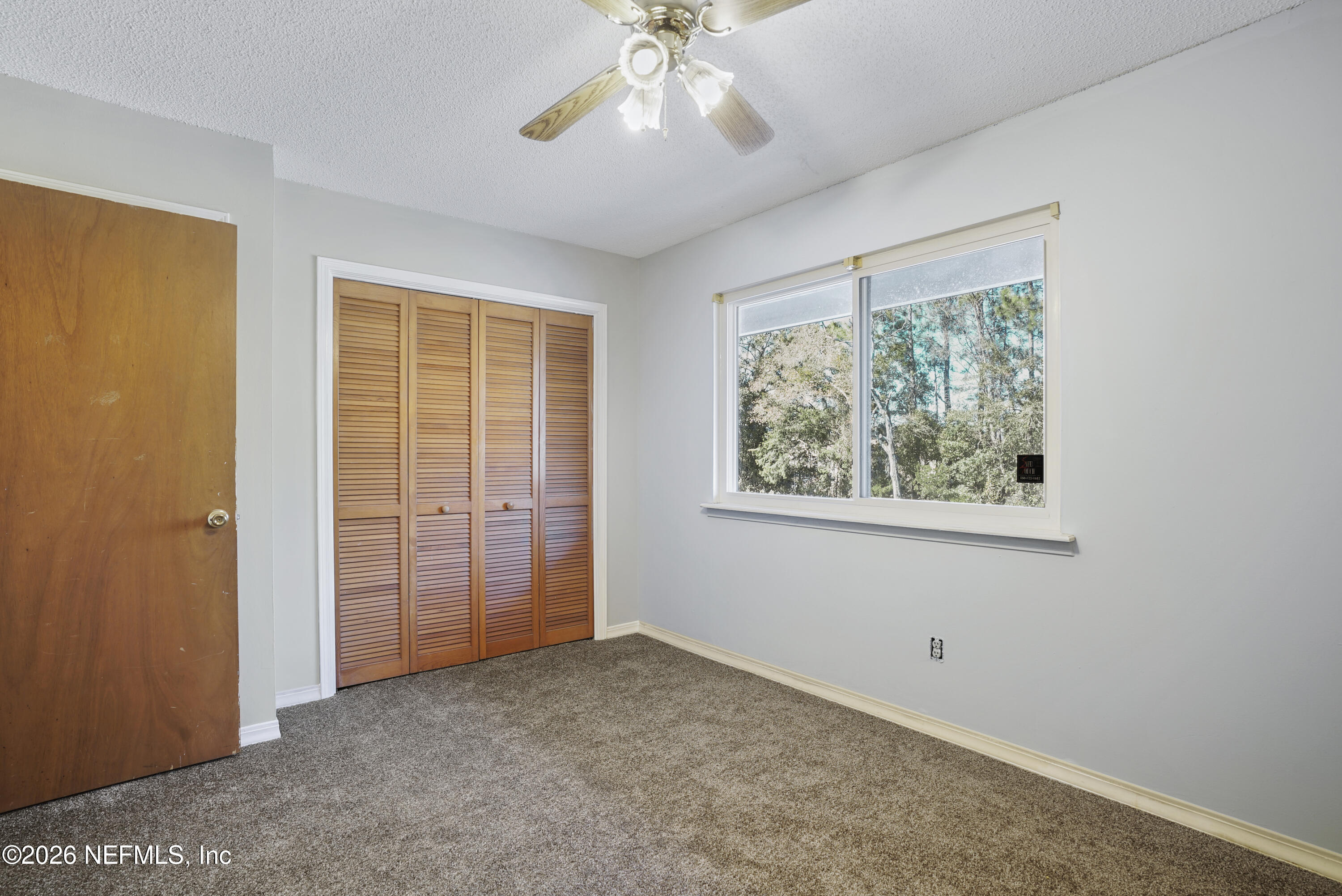3517 Peeler Road, Unit 23 Jacksonville, FL 32277 - Photo 20 of 24 an empty room with fan and windows