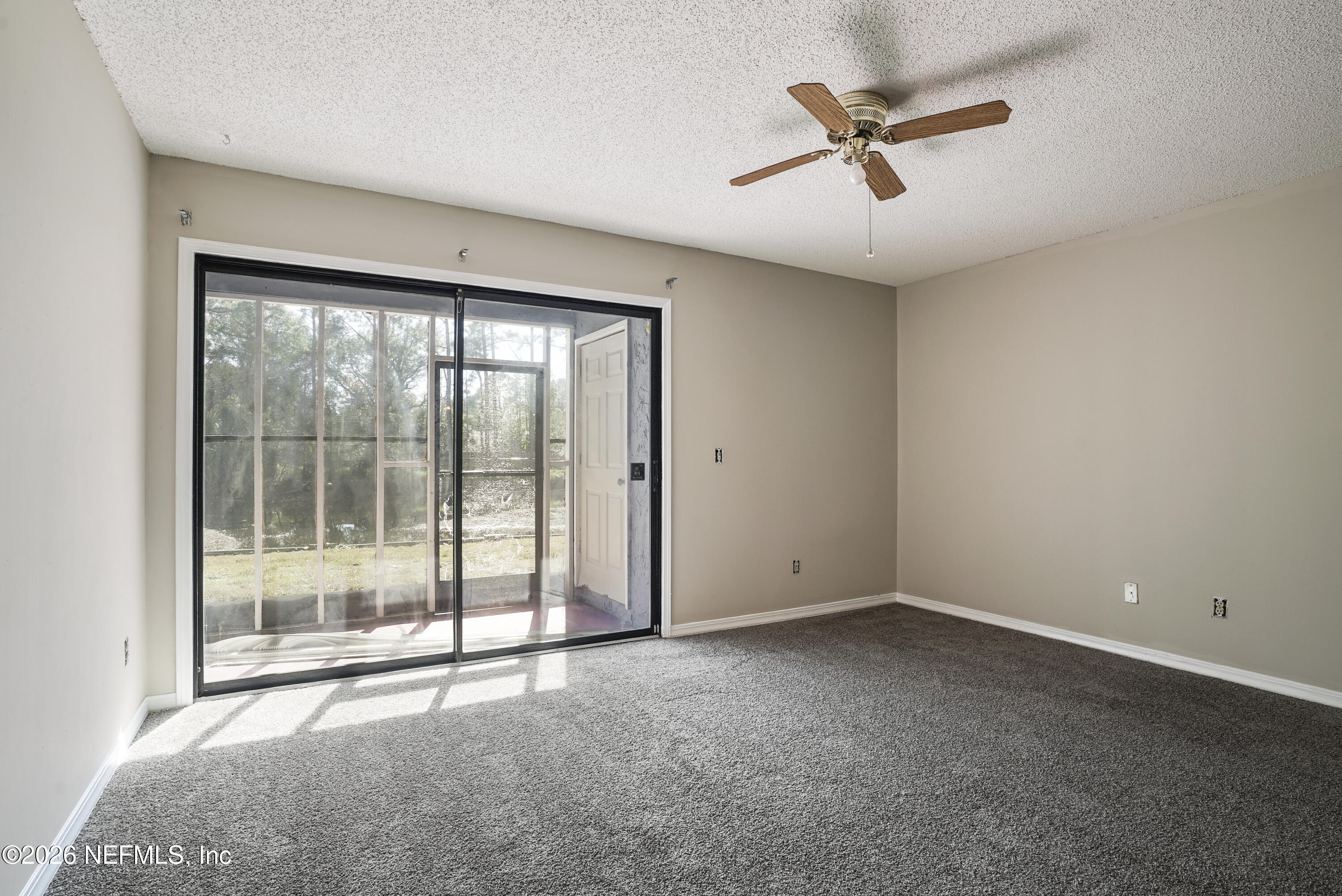 3517 Peeler Road, Unit 23 Jacksonville, FL 32277 - Photo 3 of 24 an empty room with a window