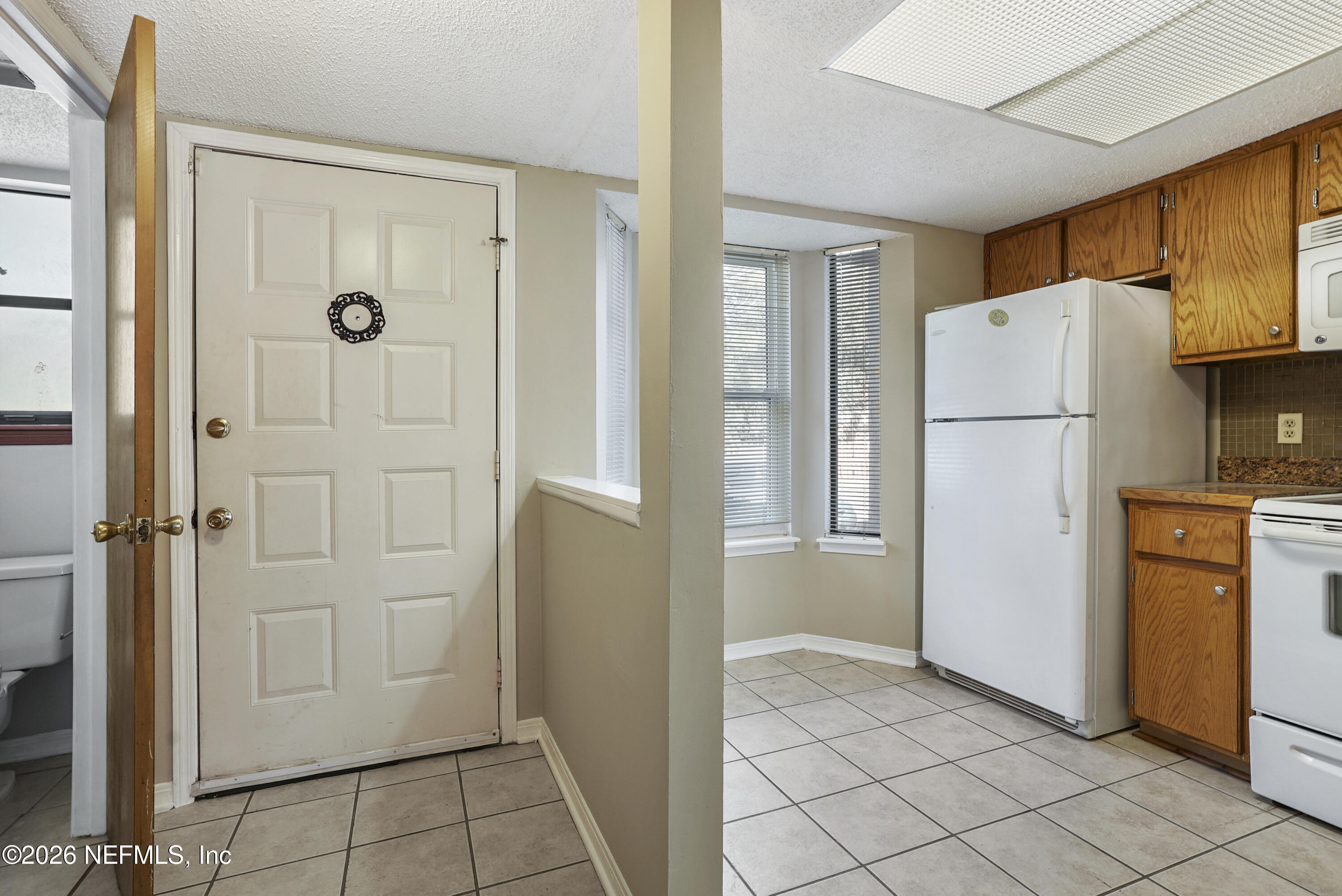 3517 Peeler Road, Unit 23 Jacksonville, FL 32277 - Photo 9 of 24 a white refrigerator freezer and a stove in a kitchen