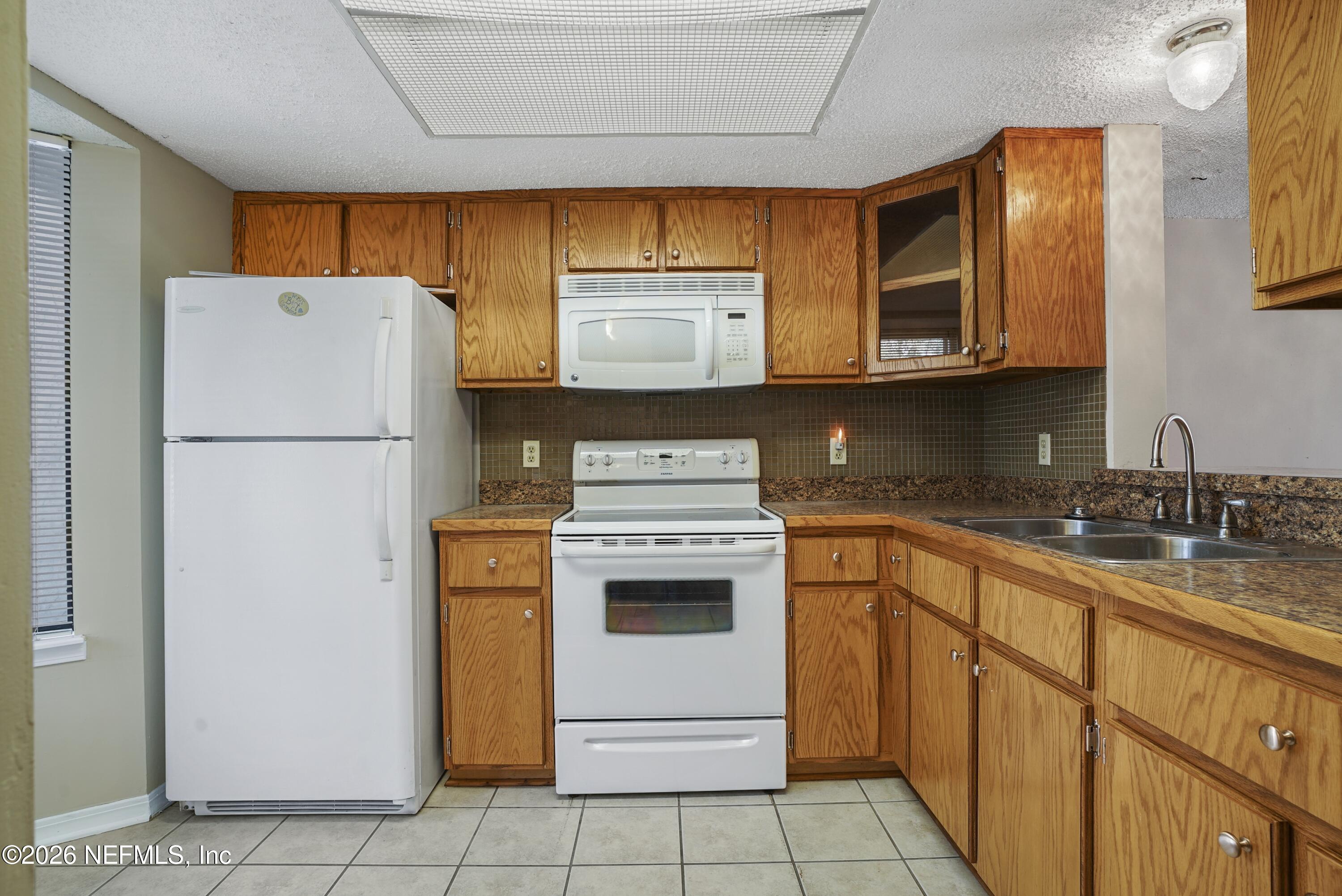3517 Peeler Road, Unit 23 Jacksonville, FL 32277 - Photo 10 of 24 a utility room with sink washer and dryer