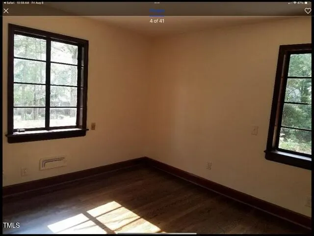 a view of a small space with wooden floor and a window