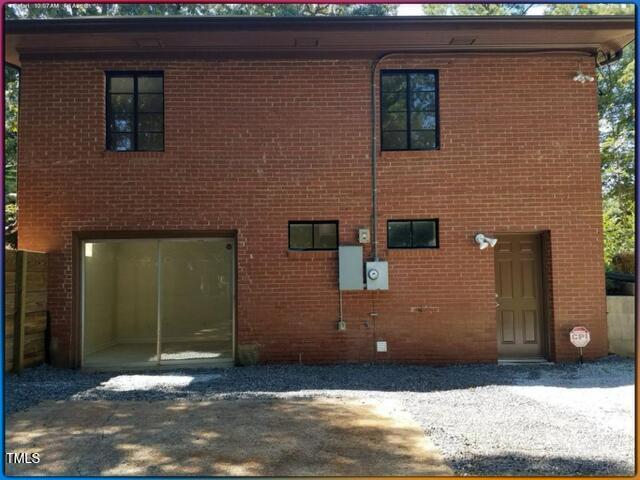 2346 Wade Avenue Raleigh, NC 27607 - Photo 3 of 20 a view of a brick house with many windows