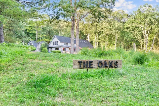 a view of a house with a yard and sitting area