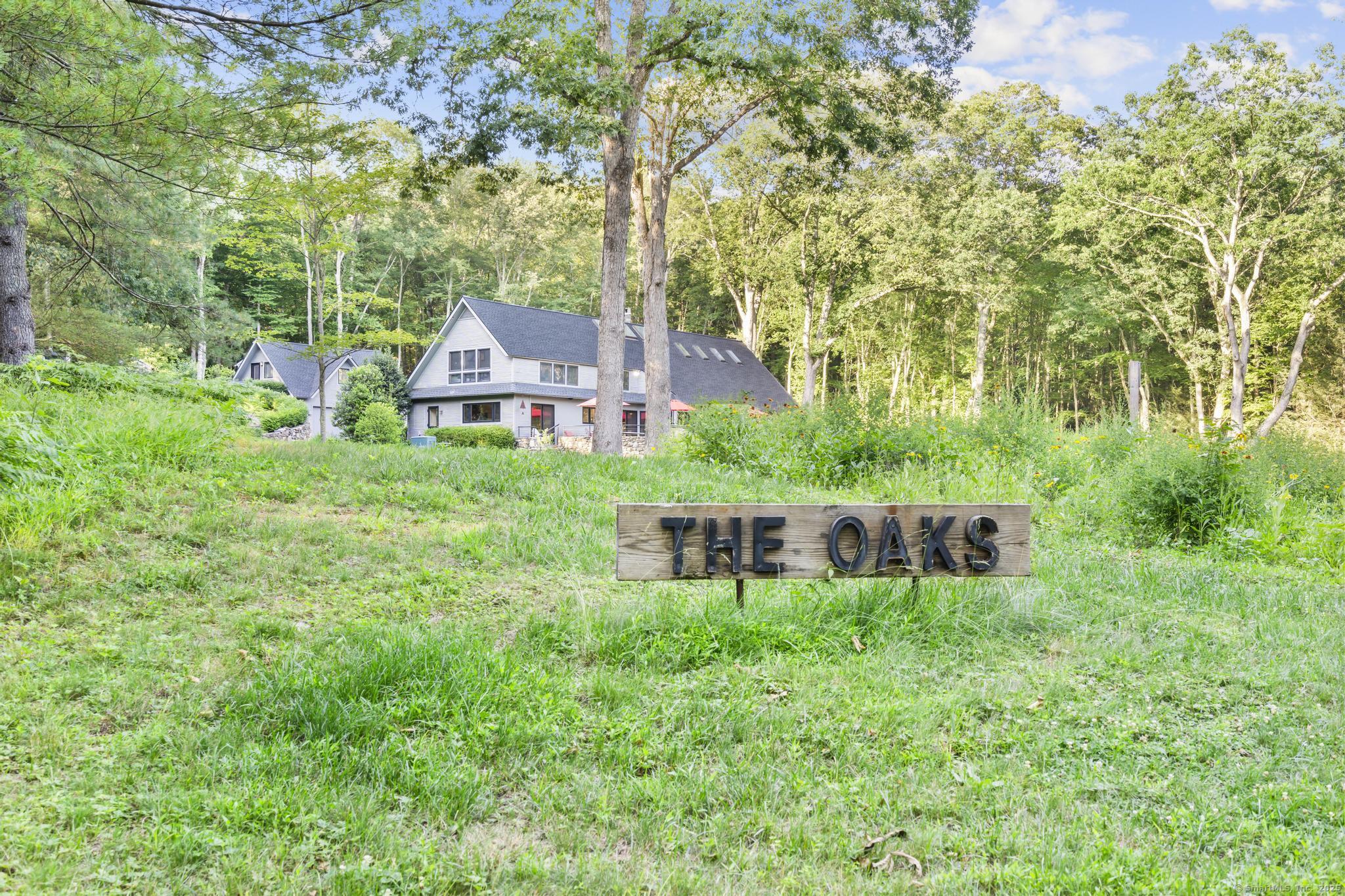 a view of a house with a yard and sitting area