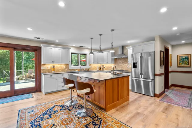 a view of a kitchen counter top space with furniture and wooden floor