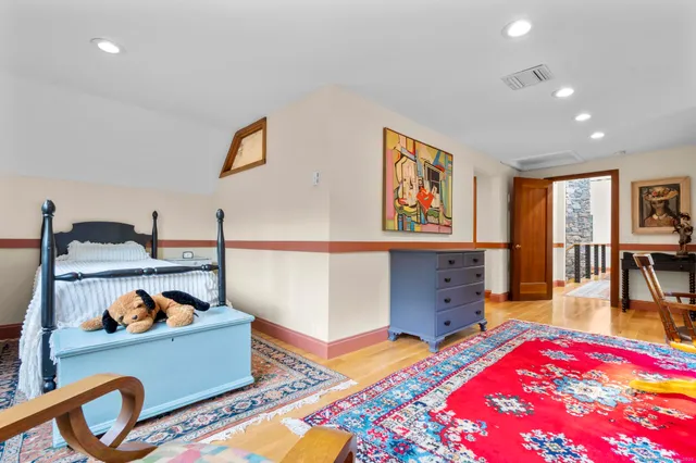 a living room with furniture a flat screen tv and a window