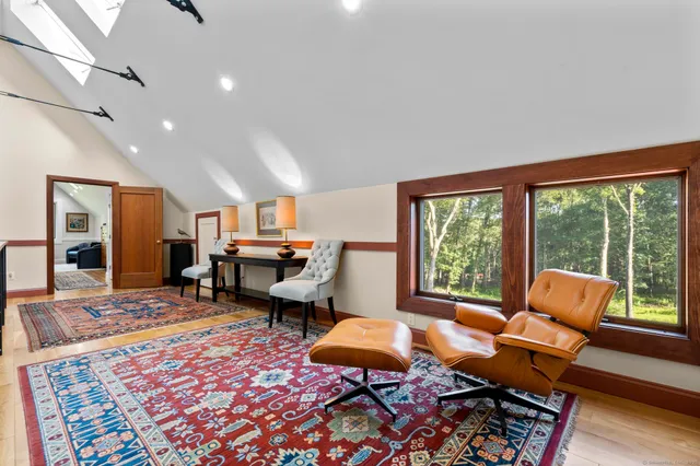 a living room with furniture rug and wooden floor