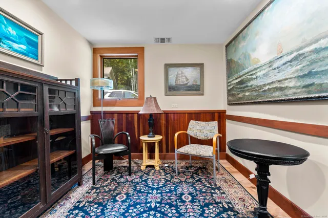 a view of a bedroom with furniture and window
