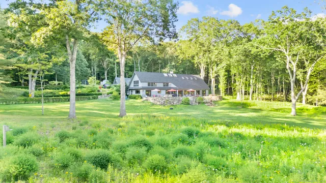 a front view of a house with a yard and fountain