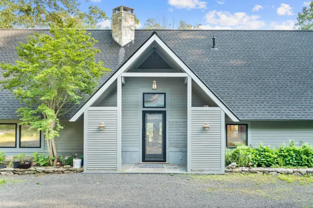 a front view of a house with a yard and a garage