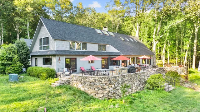 a view of a hallway with wooden floor and entryway