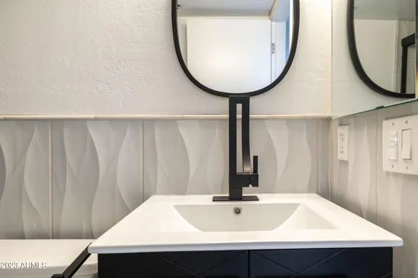 a bathroom with a sink and a mirror