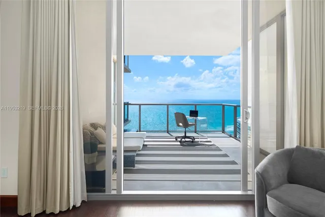 a view of living room with furniture and a floor to ceiling window