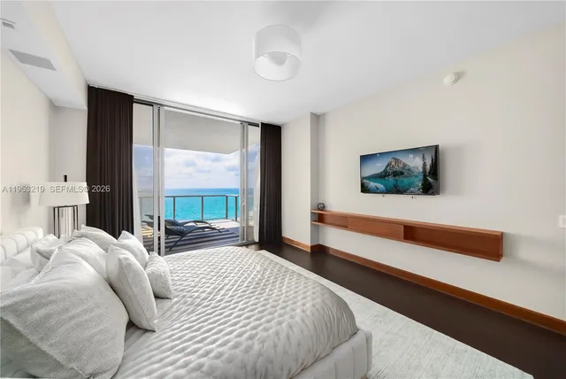 a bedroom with a large bed and a large window