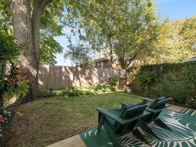 a view of a backyard with sitting area