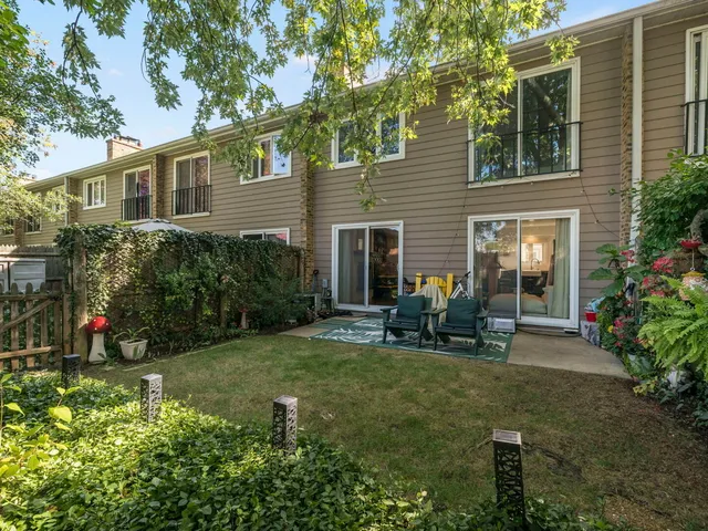a backyard of a house with outdoor seating