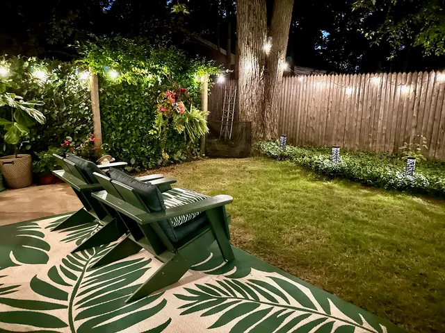 a backyard of a house with table and chairs
