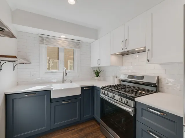 a kitchen with cabinets stainless steel appliances and a sink