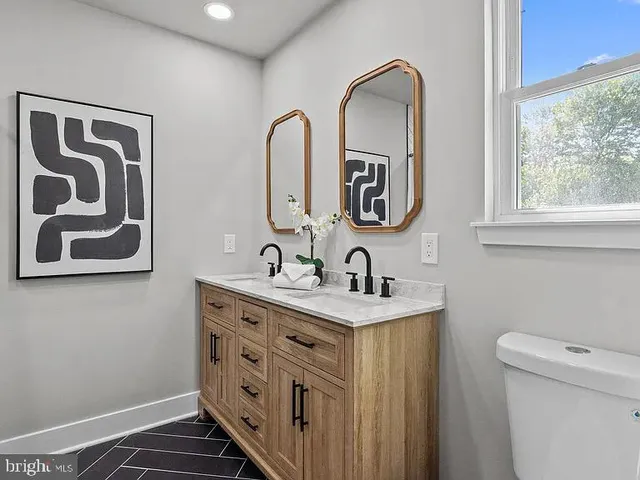 a bathroom with 2 sink and a toilet