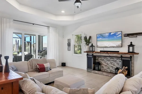 a living room with furniture a fireplace and a flat screen tv