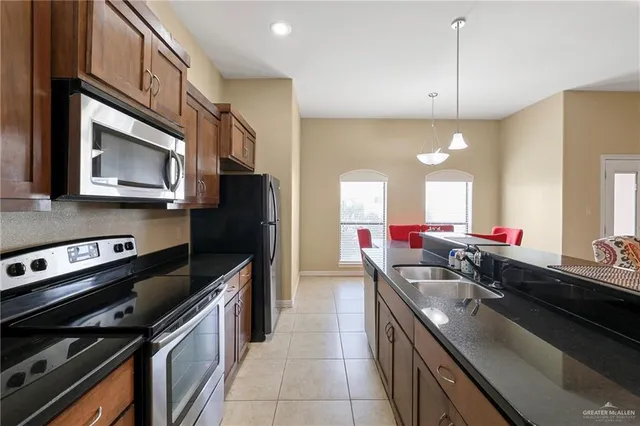 a kitchen with a sink stove and cabinets