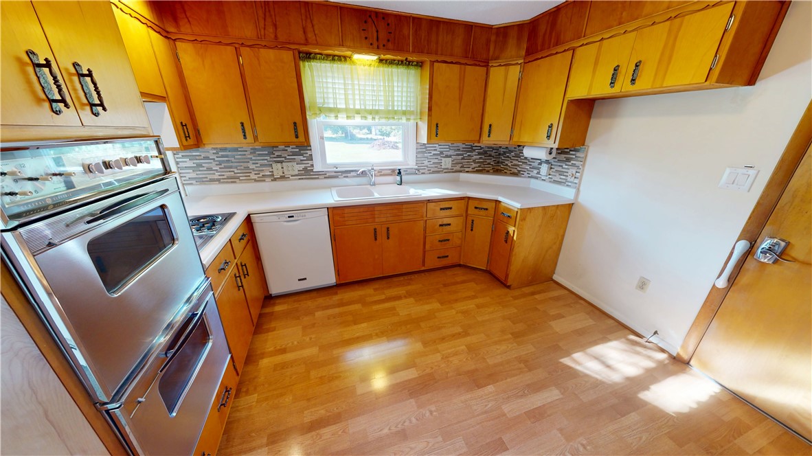 412 Panola Street Georgetown, IL 61846 - Photo 14 of 42 a kitchen with stainless steel appliances granite countertop a sink stove and refrigerator