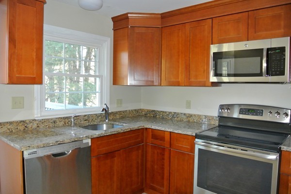 220 7 Bridge Road Lancaster, MA 01523 - Photo 4 of 21 a kitchen with granite countertop cabinets stainless steel appliances and a sink