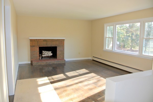 220 7 Bridge Road Lancaster, MA 01523 - Photo 8 of 21 a living room with a fireplace