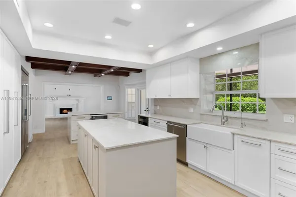 a view of a kitchen with a sink and a stove top oven