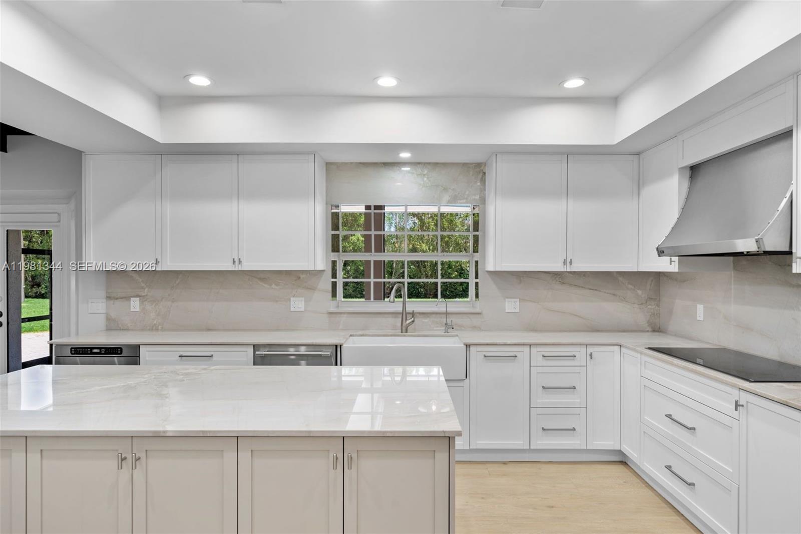6320 Hancock Road Southwest Ranches, FL 33330 - Photo 18 of 58 a kitchen with granite countertop white cabinets and window