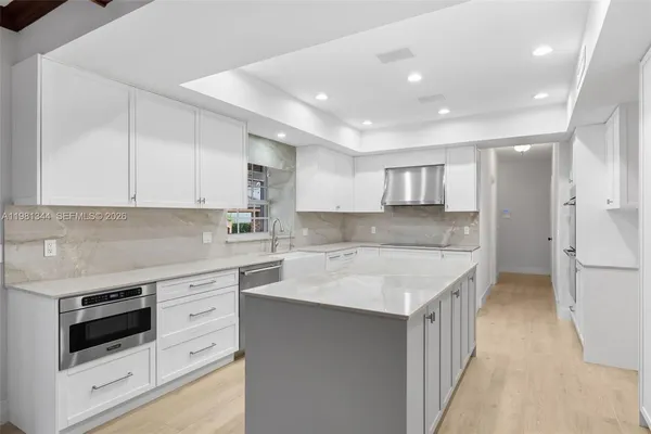 a kitchen with a sink and a refrigerator