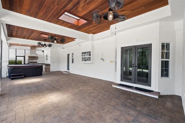 a large kitchen with stainless steel appliances lots of counter space and a sink