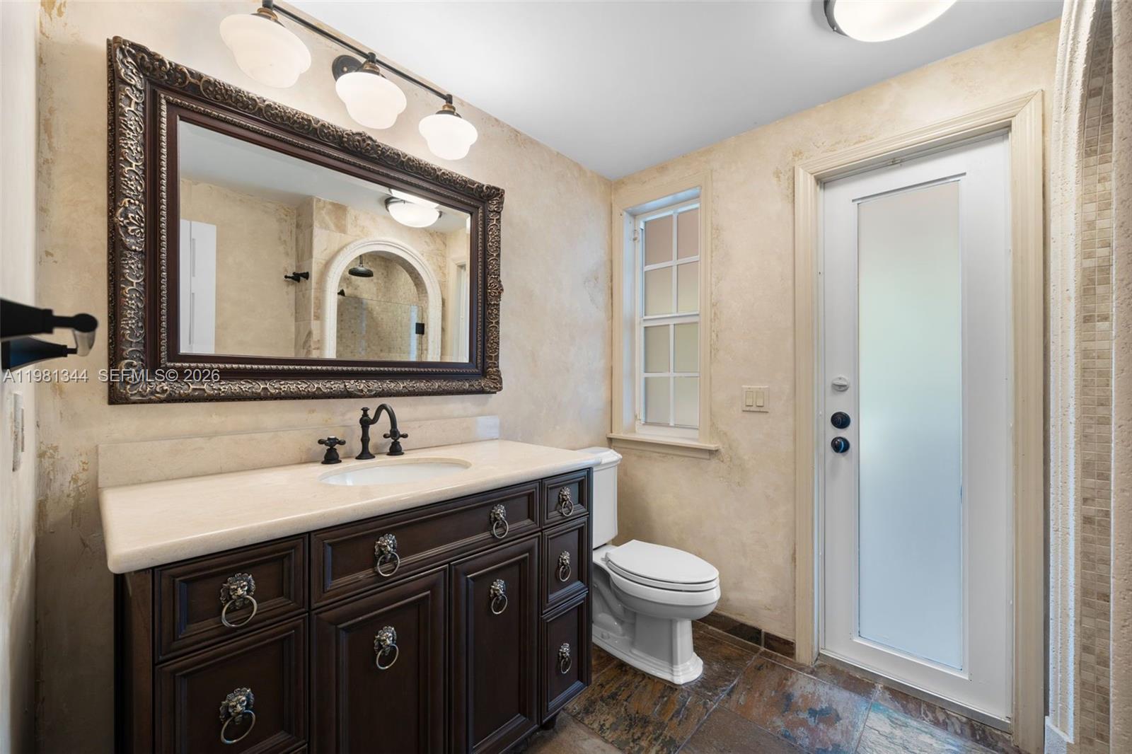 6320 Hancock Road Southwest Ranches, FL 33330 - Photo 25 of 58 a bathroom with a toilet sink and mirror