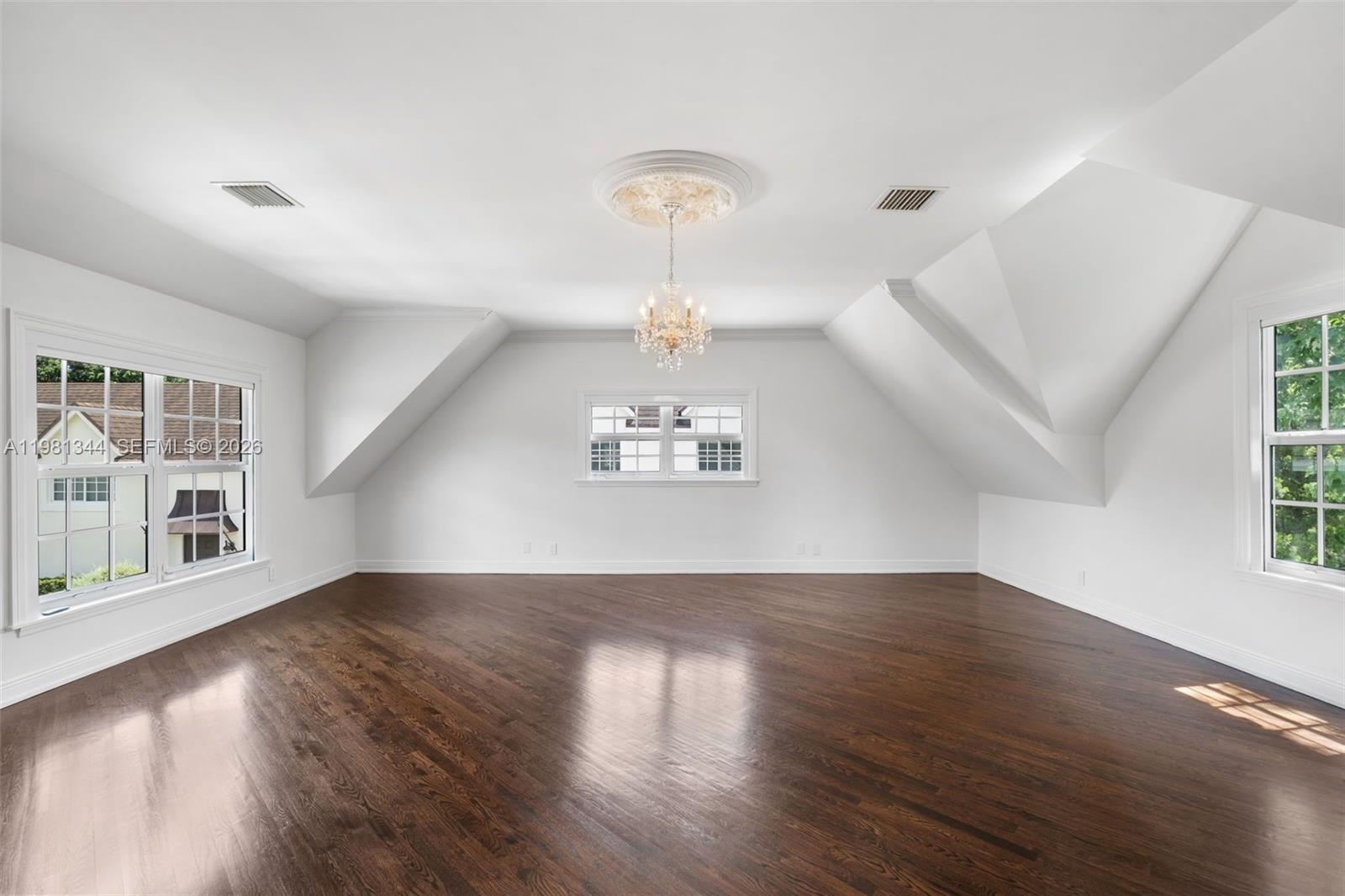 6320 Hancock Road Southwest Ranches, FL 33330 - Photo 27 of 58 an empty room with wooden floor chandelier and windows
