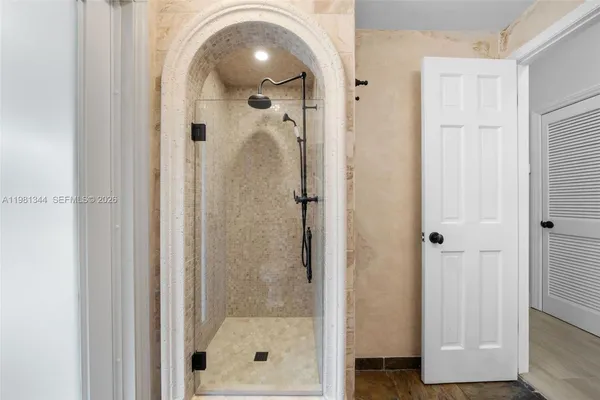 an empty room with wooden floor and closet