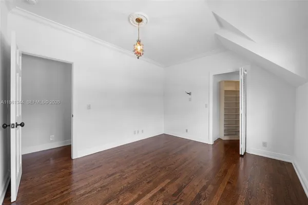 a view of a livingroom with wooden floor and window