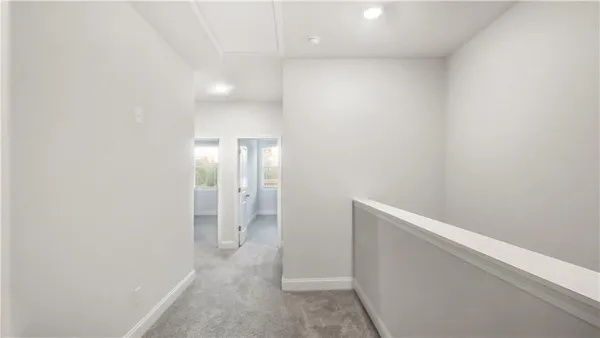 a view of hallway with bathroom