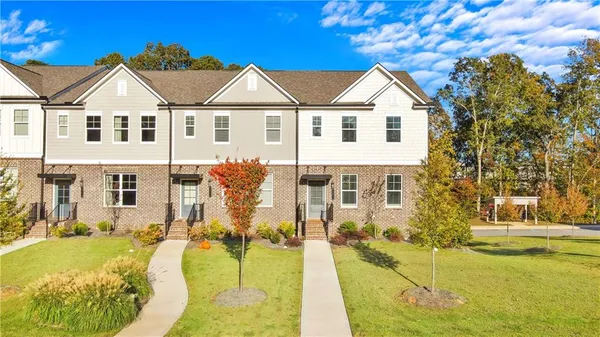 a view of a white house with a swimming pool